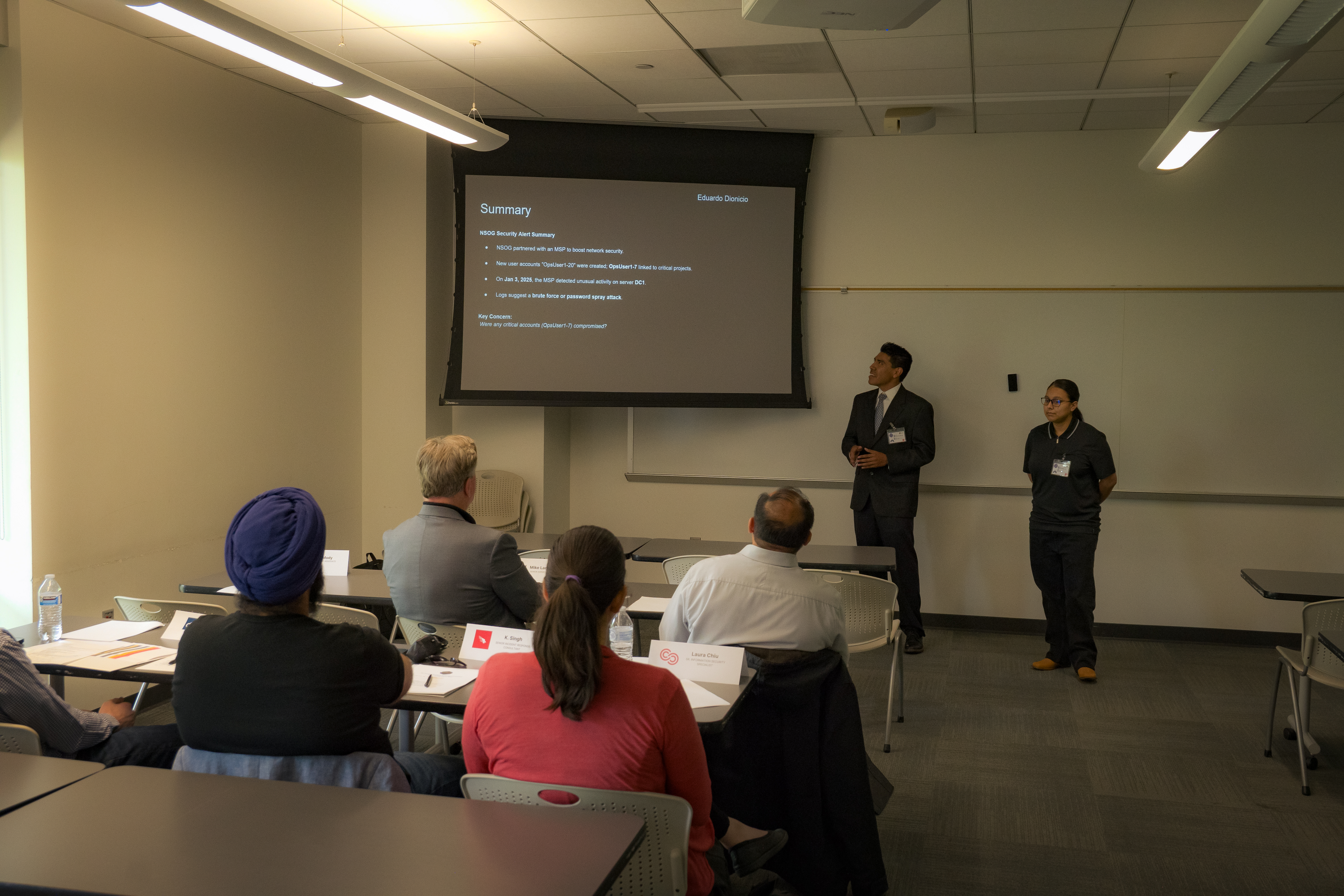 Two students presenting a summary slide